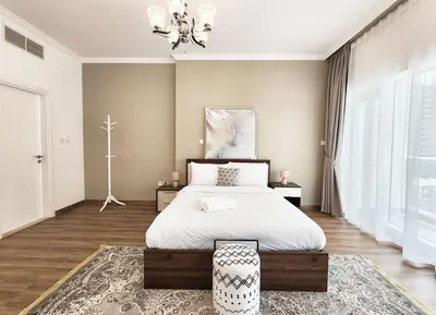 a bedroom with a bed and a chandelier at RH- Luxurious Retreat, Spacious 01 BR, near Burj Khalifa and Dubai mall in Dubai