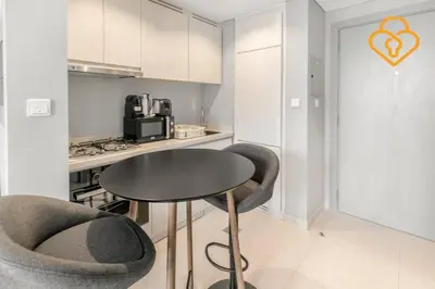 a small kitchen with a table and two chairs at Keysplease New 1 BR Apt Business Bay, Zada Tower in Dubai