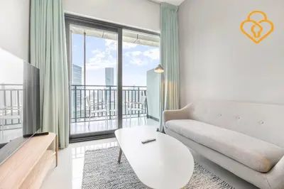 a living room with a couch and a large window at Keysplease New 1 BR Apt Business Bay, Zada Tower in Dubai