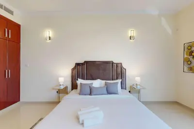 a bedroom with a large white bed with two lamps at Vacationer I Premium 3 Bedroom Apartment I Close to Marina Promenade & JBR Beach I Prime Location in Dubai