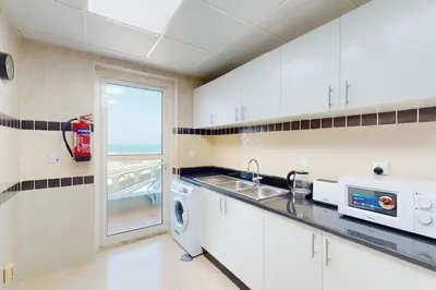 a kitchen with a sink and a washing machine at Vacationer I Premium 3 Bedroom Apartment I Close to Marina Promenade & JBR Beach I Prime Location in Dubai