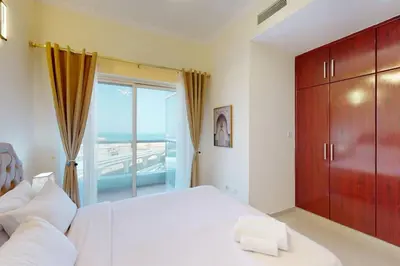a bedroom with a large white bed and a large window at Vacationer I Premium 3 Bedroom Apartment I Close to Marina Promenade & JBR Beach I Prime Location in Dubai