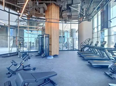 a gym with rows of treadmills and machines at 15 Northside - Chic Studio in Dubai