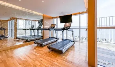 a gym with two exercise bikes in a room at Delightful Studio at Carson A DAMAC Hills Dubailand by Deluxe Holiday Homes in Dubai