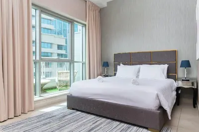 a bedroom with a large bed and a large window at BellaVista - Spectacular - 2 BR Penthouse - Boulevard Central - Panoramic Terrace & Burj Khalifa View in Dubai
