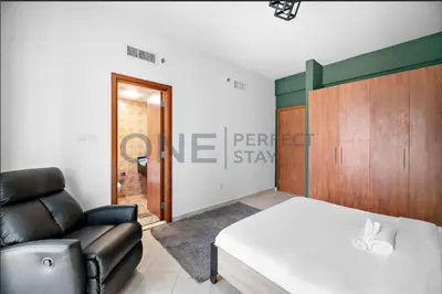 a living room with a bed and a couch at Lake View All Bills Included Fully furnished in Dubai