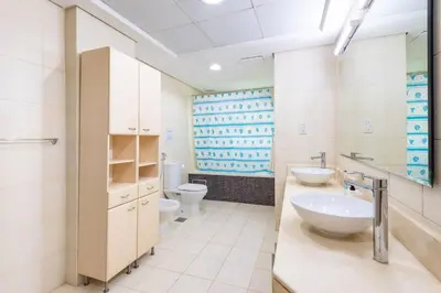 a bathroom with two sinks and two toilets at Dubai The Palm 4BR Beach & Pool Access in Dubai