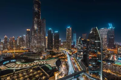 a night view of a city with tall buildings at GuestReady - Fashion Avenue | Burj Khalifa View in Dubai