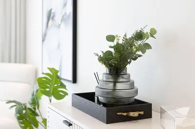a vase of flowers on a table in a living room at Magnificent - Luxurious 3 BR with Marina View in Dubai