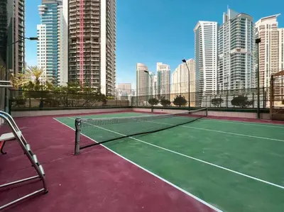 a tennis court in a city with tall buildings at Magnificent - Luxurious 3 BR with Marina View in Dubai
