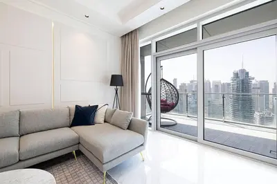 a living room with a couch and a large window at Magnificent - Luxurious 3 BR with Marina View in Dubai