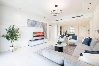 a living room with a couch and a tv at Magnificent - Luxurious 3 BR with Marina View in Dubai