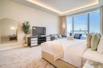 a large bedroom with a large bed and a television at Heavenly Studio at The Palm Tower Palm Jumeirah by Deluxe Holiday Homes in Dubai