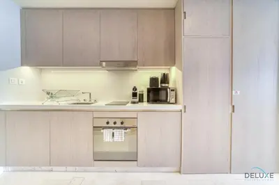 a kitchen with a stove and a microwave at Heavenly Studio at The Palm Tower Palm Jumeirah by Deluxe Holiday Homes in Dubai