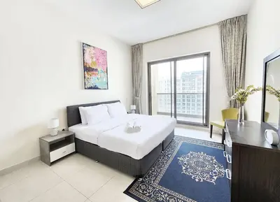 a hotel room with a bed and a large window at RH- Captivating Skyline View, 02BR Near Clemance Medical Center in Dubai