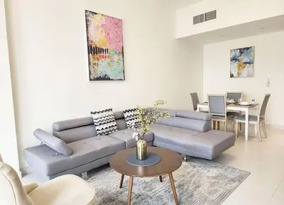 a living room with a couch and a table at RH- Captivating Skyline View, 02BR Near Clemance Medical Center in Dubai