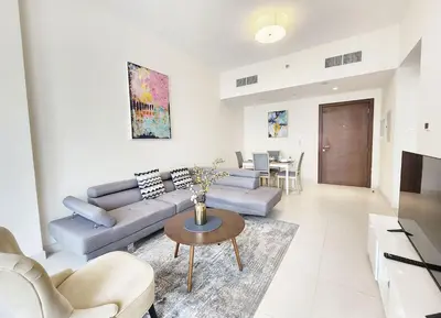 a living room with a couch and a table at RH- Captivating Skyline View, 02BR Near Clemance Medical Center in Dubai