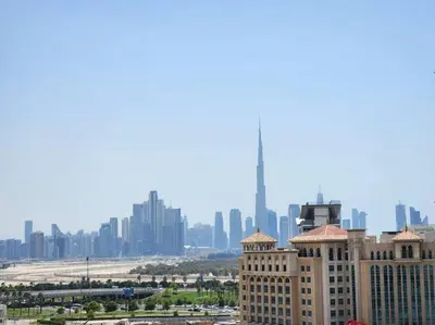 a view of a building with a city in the background at RH- Captivating Skyline View, 02BR Near Clemance Medical Center in Dubai