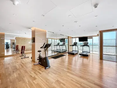 a gym with treadmills and exercise equipment in a building at Luxurious - Studio - Damac Hills - Pool & Gym in Dubai