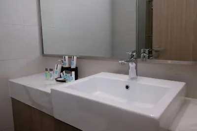 a bathroom with a white sink and a mirror at Mira Holiday Homes - Cozy studio in Meydan in Dubai