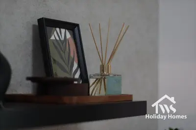 a shelf with two mirrors and a container with sticks at The Urban Oasis - Serenity in Dubai