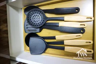 a wooden box with a bunch of cooking utensils at The Urban Oasis - Serenity in Dubai
