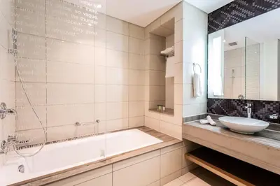 a bathroom with a tub and a sink at ALiving Elite 2BR I Burj Khalifa View I Paramount Towers, 6102 in Dubai