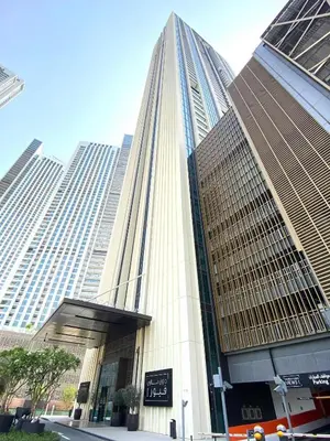 a tall building with a sign in front of it at Silkhaus modern 1BDR in Downtown with balcony, pool, gym in Dubai