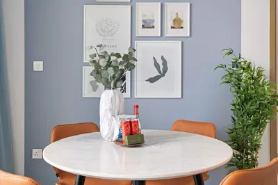 a white table with a vase of flowers on it at Silkhaus modern 1BDR in Downtown with balcony, pool, gym in Dubai