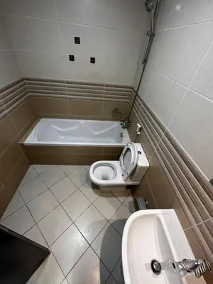 a bathroom with a toilet and a tub and a sink at Cute Rooms and Small Partitions for Girls in Dubai- Female guests only فتيات فقط in Dubai