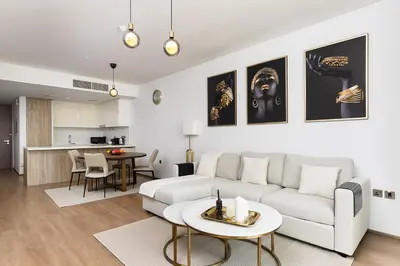 a living room with a couch and a table at New apt in Dubai Marina with balcony and sea view in Dubai