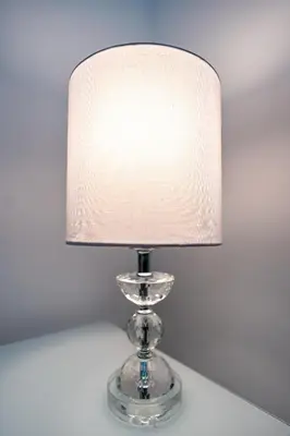 a clear glass table lamp with a white lamp shade at New apt in Dubai Marina with balcony and sea view in Dubai