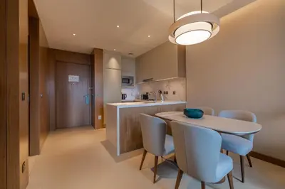 a kitchen and dining room with a table and chairs at Premium 1BDR Apartment in Downtown Opera in Dubai