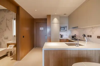 a kitchen with a sink and a counter top at Premium 1BDR Apartment in Downtown Opera in Dubai