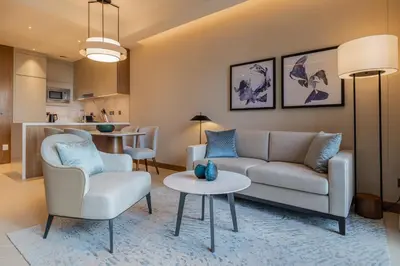 a living room with a couch and chairs and a table at Premium 1BDR Apartment in Downtown Opera in Dubai