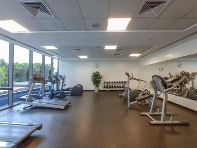 a gym with treadmills and machines in a room at Prime Stylish Studio with Marina Views in Dubai