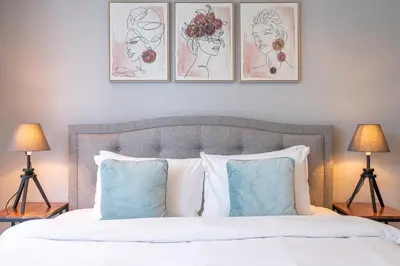 a bedroom with a bed with three pictures on the wall at Prime Stylish Studio with Marina Views in Dubai