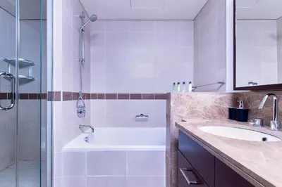 a bathroom with a tub and a sink and a shower at Bellavista - Striking - 1BR with Extra Twin Room - 29 boulevard - Partial Fountain View in Dubai
