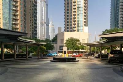 a parking lot in a city with tall buildings at Bellavista - Striking - 1BR with Extra Twin Room - 29 boulevard - Partial Fountain View in Dubai
