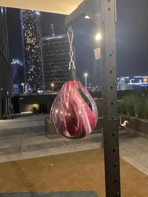 a red bag hanging from a pole with a city skyline at The Suite Dubai 15 Northside Luxury Living in Dubai