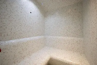 a corner of a bathroom with a white tiled wall at The Suite Dubai 15 Northside Luxury Living in Dubai