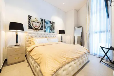 a bedroom with a large bed with a yellow bedspread at The Suite Dubai 15 Northside Luxury Living in Dubai