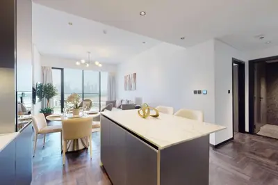 a kitchen and living room with a table and chairs at O Ten, Al Jaddaf - Smart One Bedroom in Dubai