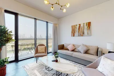 a living room with a couch and a table at O Ten, Al Jaddaf - Smart One Bedroom in Dubai