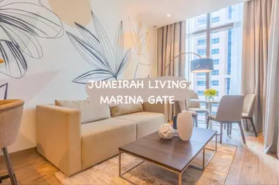 a living room with a couch and a table at Maison de Luxe - Jumeirah Living Marina Gate in Dubai