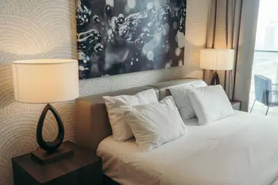 a bedroom with a bed with white pillows at Maison de Luxe - Jumeirah Living Marina Gate in Dubai