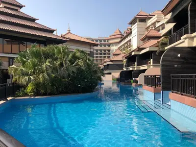 a large swimming pool in the middle of a building at GuestReady - Burj Al Arab view at Royal Amwaj in Dubai