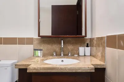 a bathroom with a sink and a mirror at Bellavista - High Floor - 1BR - 29 Boulevard - Burj Khalifa & Fountain View in Dubai