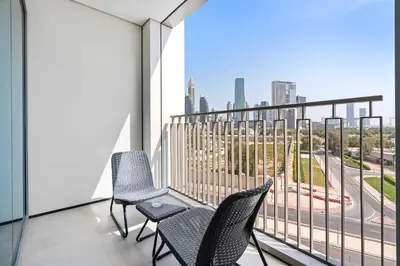 a balcony with chairs and a view of the city at Silkhaus furnished 1BDR in Downtown new tower in Dubai
