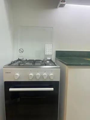 a stove top oven in a kitchen next to a counter at Diamond Tower Marina Apartment in Dubai